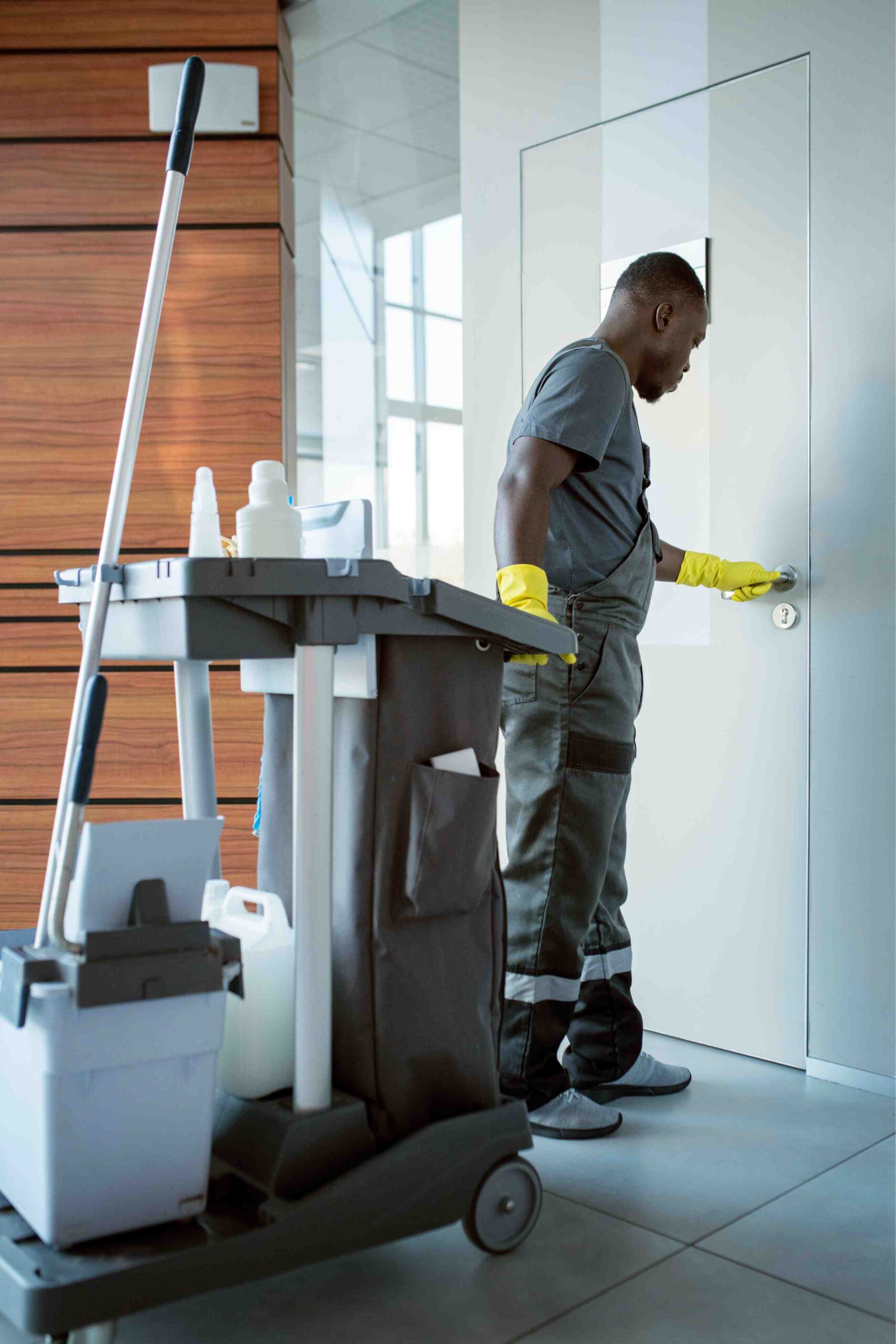 Cleaner disinfecting a door handle